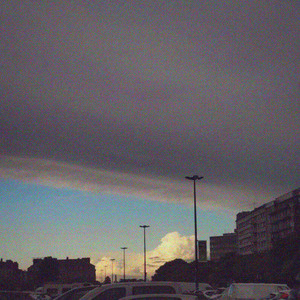 Rolling Black Clouds on a Blue Canvas