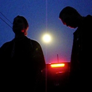 Strangers (Looking in on the Same Grave)