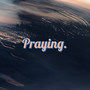 Praying.